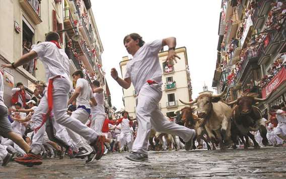 Runners sprint yesterday during the first running of the bulls of Pamplonau2019s San Fermin festival this year.