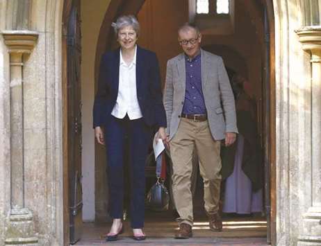 Prime Minister Theresa May and her husband Philip leave after attending a church service in Sonning yesterday.