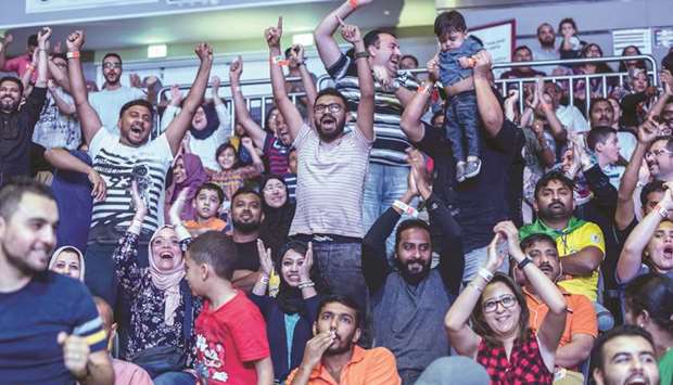 Football fans cheer for their favourite teams at the fan zone.