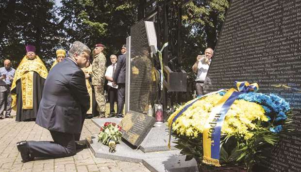 Ukrainian President Petro Poroshenko takes part in the opening of a memorial paying tribute to Ukrainians killed by Polish partisans, in the Polish village of Sahryn.