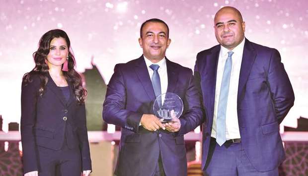Kamal (centre) with the award GWC received from Microsoft for its u201coutstanding achievementsu201d in  digital transformation, with other officials.
