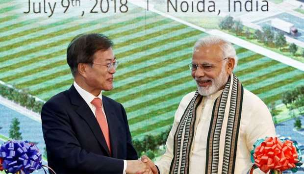 South Korean President Moon Jae-in and Indian Prime Minister Narendra Modi shake hands after inaugurating the Samsung Electronics smartphone manufacturing facility in Noida