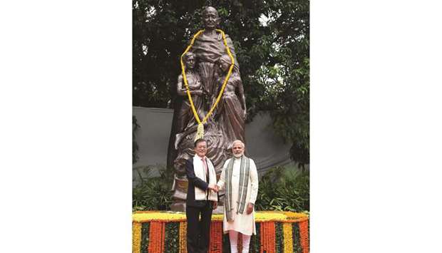 Prime Minister Narendra Modi and South Korea President Moon Jae-in shakes hands as they pay tribute at the National Gandhi Museum in New Delhi yesterday.