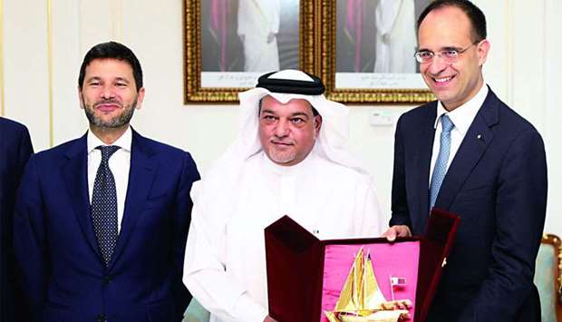 Italian National Coldiretti Union national president Roberto Moncalvo receives a token from Qatar Chamber board member Mohamed bin Ahmed al-Obaidly while Italian ambassador Pasquale Salzano looks on.