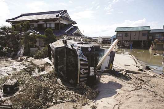 Destroyed houses and cars are seen in in Mabi town in Kurashiki, Okayama Prefecture, Japan, yesterday.