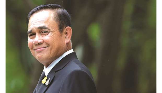 In this file photo, Thai Prime Minister Prayut Chan-o-cha smiles before speaking to the media at Government House in Bangkok.