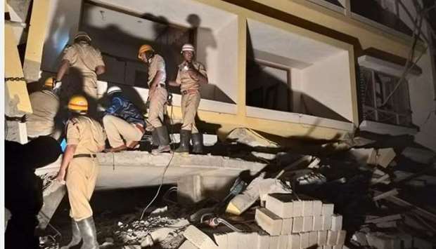 Fire and rescue personnel look for people trapped inside the collapsed building. Photo courtesy: The News Minute