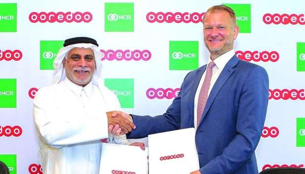 Ooredoo Qatar COO Yousuf Abdulla al-Kubaisi and Richard Richardson, vice-president T&T EMEA at NCR, shaking hands after signing the contract in a ceremony held recently in Doha.
