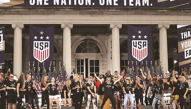 US players celebrate at the Womenu2019s World Cup Champions Parade at City Hall in New York City yesterday. (AFP)