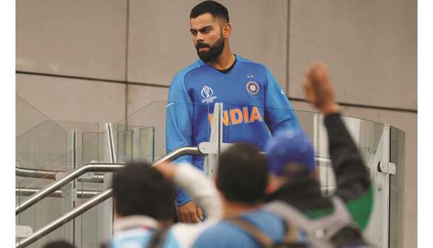 Indiau2019s Virat Kohli walks down from the dressing room after the loss to New Zealand in Manchester, United Kingdom, yesterday. (Reuters)