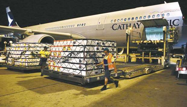 Polystyrene boxes sit on a hydraulic lift to be loaded into the cargo hold of a Cathay Pacific Airways aircraft. Weak global trade volumes and tensions between governments have contributed to a decline in new export orders and dented the air freight segment.