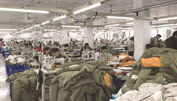 Workers make Orolay jackets at the companyu2019s factory complex in Jiaxing, Zhejiang province.