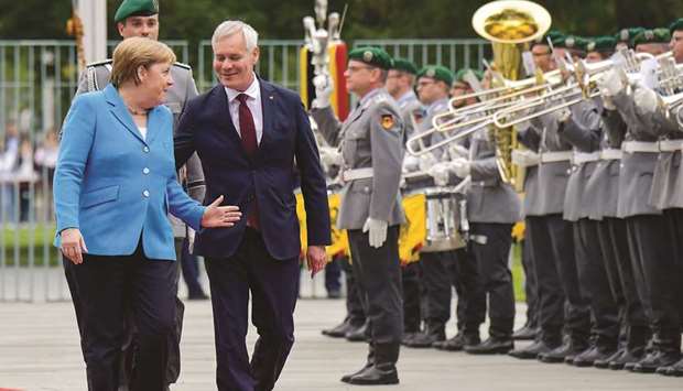 German Chancellor Angela Merkel and Finlandu2019s Prime Minister Antti Rinne review an honour guard during a welcoming ceremony at the Chancellery in Berlin yesterday.