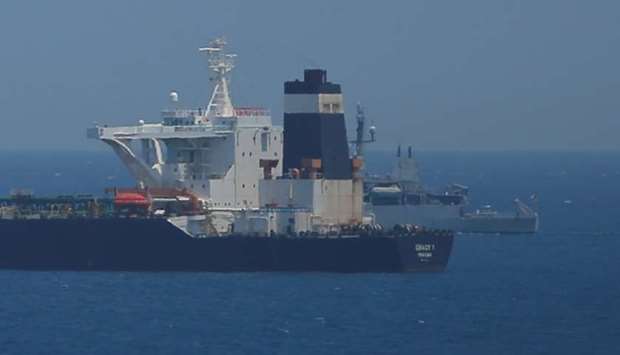 British Royal Navy patrol vessel guards the oil supertanker Grace 1, suspected of carrying Iranian crude oil to Syria, as it sits anchored in waters of the British overseas territory of Gibraltar on July 4