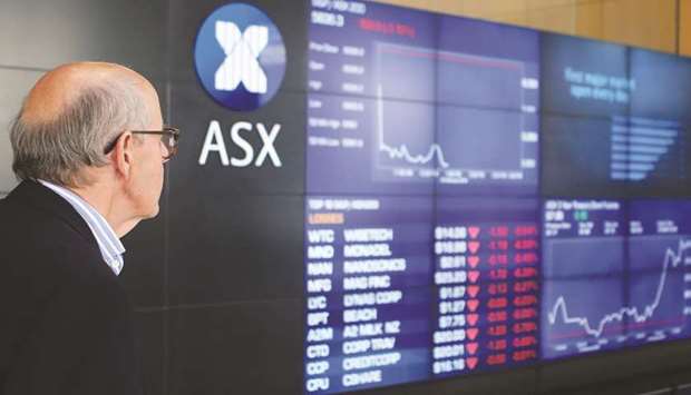 A man looks at the main board at the Australian Securities Exchange building in central Sydney.