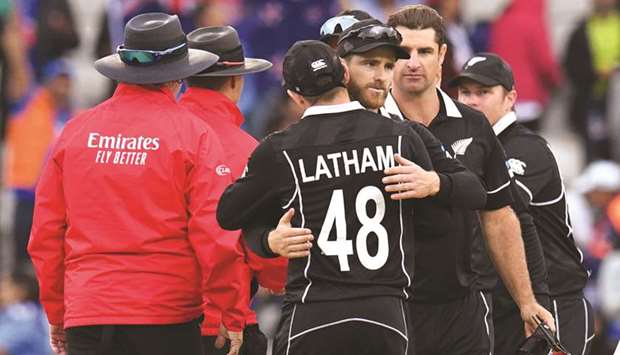 New Zealandu2019s captain Kane Williamson (centre) hugs teammate Tom Latham in celebration after winning the 2019 ICC Cricket World Cup semi-final against India at Old Trafford in Manchester, United Kingdom, on Wednesday. (AFP)