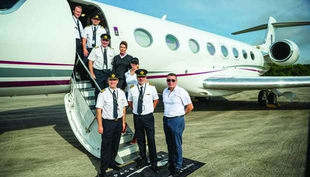 Qatar Executive crew with the u2018One More Orbitu2019 team pose in front of the Gulfstream G650ER