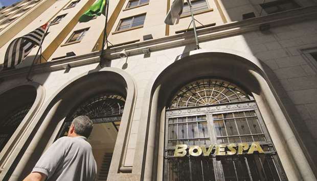 Pedestrians walk past the Bovespa Stock Exchange in Sao Paulo, Brazil.