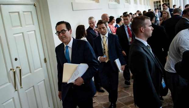 US Secretary of the Treasury Steven Mnuchin walks past the Rose Garden of the White House July 11