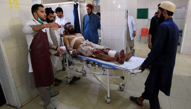 An injured man receives a treatment at the hospital, after a suicide attack in Jalalabad, Afghanistan