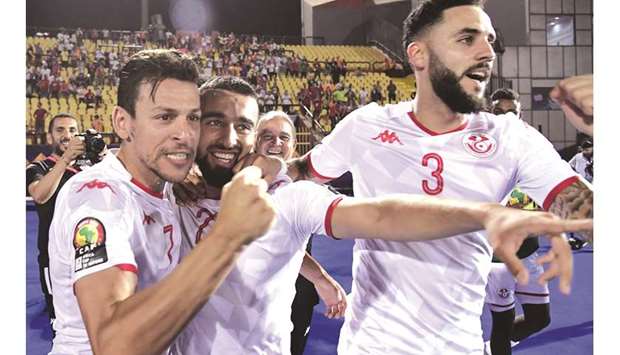 Tunisiau2019s Naim Sliti (centre) celebrates with teammates after scoring a goal during the Africa Cup of Nations quarter-final match against Madagascar in Cairo. (AFP)
