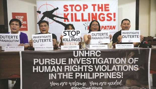 Human rights advocates and defenders in the Philippines led by Tinay Palabay (second right) of Karapatan, an alliance for the advancement of peopleu2019s rights, show placards during a press conference in Manila yesterday, a day after the United Nations Human Rights Council approved a resolution mandating a comprehensive international review of the drug war in the Philippines.