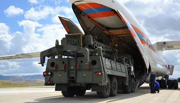 First parts of a Russian S-400 missile defence system are unloaded from a Russian plane at Murted Airport, known as Akinci Air Base, near Ankara, Turkey
