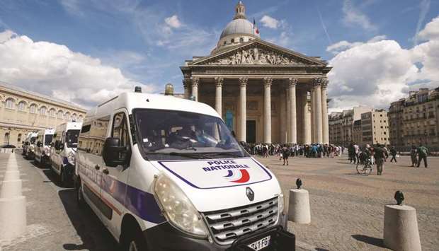 Police vans are seen in front of the Pantheon, occupied by undocumented migrants in Paris.