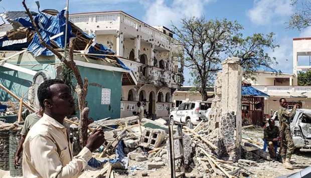 A man passes in front of the rubbles of the popular Medina hotel of Kismayo today.