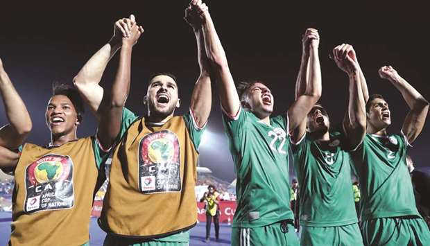 Algerian players celebrate after winning the 2019 Africa Cup of Nations (CAN) quarter-final against Ivory Coast at the Suez stadium in Suez on Thursday.