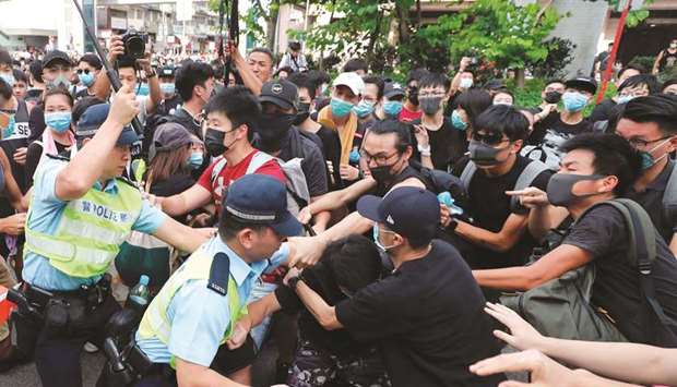 Police try to disperse pro-democracy activists after a march at Sheung Shui, a border town in Hong Kong yesterday.