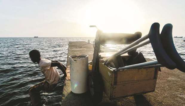 Disabled diver Ernesto Maklin jumps from a dock into the water in Puerto Lempira, Honduras. Thousands of fishing divers of the Mosquitia region, where lobster diving industry is the most important incoming for the economy, suffer decompression sickness that can cause pain in the muscles and joints, cramps, numbness, nausea, permanent paralysis and even death.