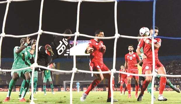 Tunisiau2019s defender Dylan Bronn (right) scores an own goal during the Africa Cup of Nations semi-final against Senegal in Cairo yesterday. (AFP)