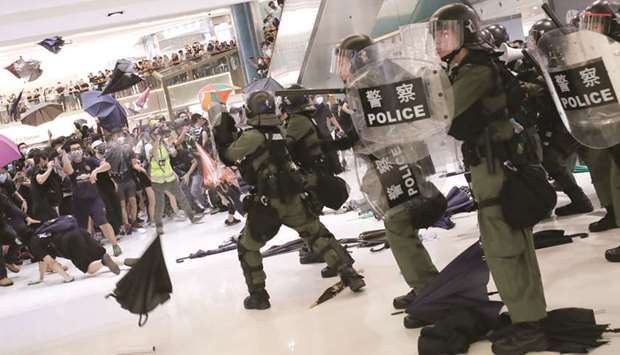 Riot police use pepper spray to disperse pro-democracy activists inside a mall after a march at Sha Tin District of East New Territories in Hong Kong yesterday.