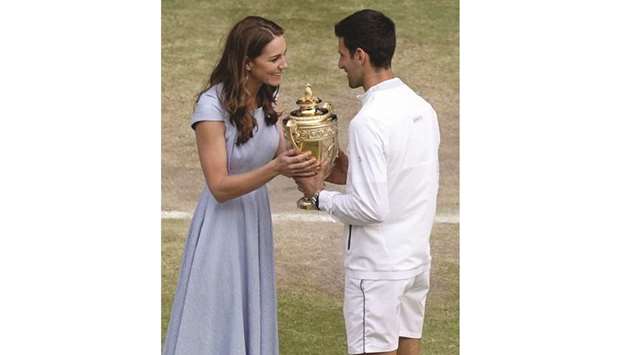 Britainu2019s Catherine, Duchess of Cambridge, hands the winneru2019s trophy to Serbiau2019s Novak Djokovic at The All England Lawn Tennis Club in Wimbledon, southwest London, yesterday.
