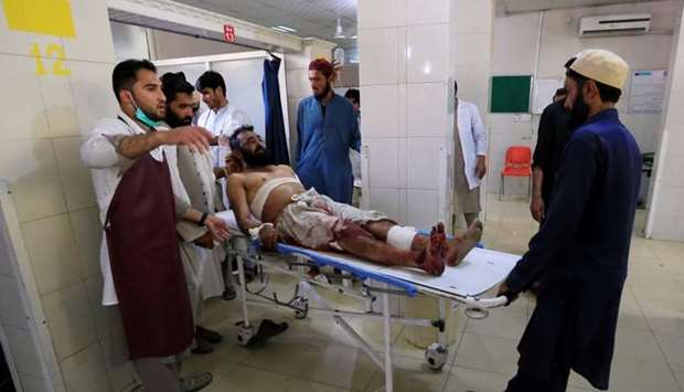 An injured man receives a treatment at the hospital, after a July 12 suicide attack in Jalalabad