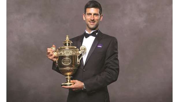 A handout picture released by the All England Lawn Tennis and Croquet Club  yesterday shows 2019 Wimbledon champion Novak Djokovic posing with his trophy at the Champions Dinner on Sunday.