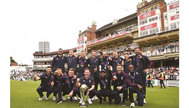 England players pose with the World Cup trophy during a victory event at The Oval in London yesterday. (AFP)