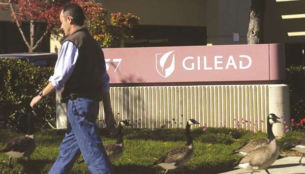 A man walks past Gilead Sciences offices in Foster City, California.