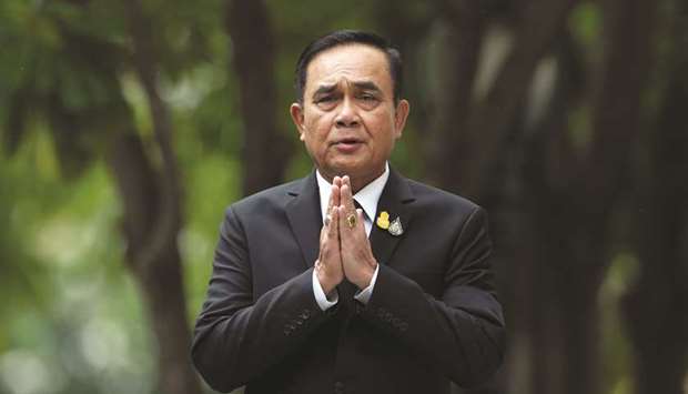 Thai Prime Minister Prayut Chan-o-cha gestures while speaking to media members at the Government House in Bangkok.
