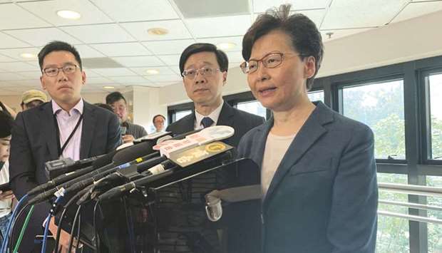 Hong Kong Chief Executive Carrie Lam, right, and Secretary for Security John Lee Ka-chiu speak to media over an extradition bill protest in Hong Kong yesterday.