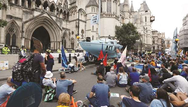 Extinction Rebellion climate activists hold a protest outside the Royal Courts of Justice in London, Britain, yesterday.