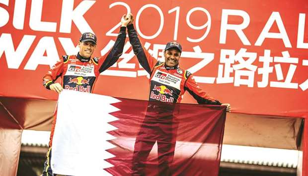 Qataru2019s Nasser al-Attiyah (right) and French co-driver Mathieu Baumel celebrate their Silk Way Rally victory in Dunhuang, China