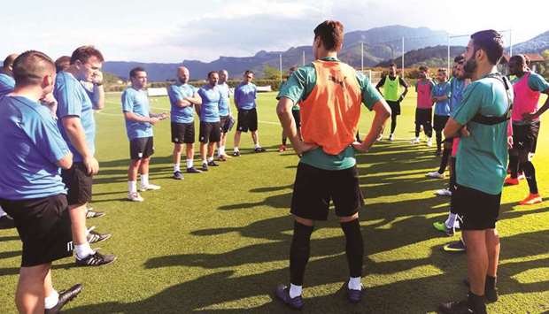 Al Saddu2019s new head coach Xavi Hernandez (third left) talks to his players during a pre-season training camp in Olot, Spain.