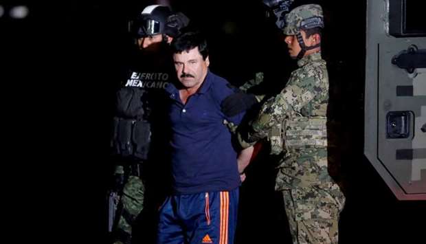 Joaquin ,El Chapo, Guzman is escorted by soldiers during a presentation in Mexico City, January 8, 2016