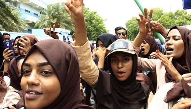 Scores of students of a Khartoum-based university celebrate after an agreement was reached between protest leaders and members of the transitional military council in the Sudanese capital