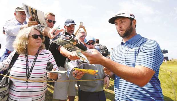 Spainu2019s Jon Rahm signs autographs during a practice round in Portrush, Northern Ireland, ahead of the 148th Open Championship. (Reuters)