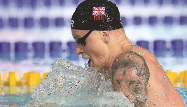 In this file photo taken on August 4, 2018 Britainu2019s Adam Peaty competes in the menu2019s 100m breaststroke final at the Tollcross Swimming Centre during the 2018 European Championships in Glasgow. (AFP)