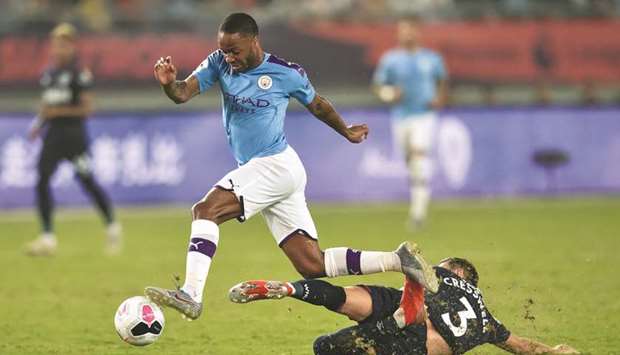 Manchester Cityu2019s Raheem Sterling (left) vies for the ball with West Ham Unitedu2019s Aaron Cresswell during the Premier League Asia Trophy football tournament in Nanjing in Chinau2019s Jiangsu province yesterday. (AFP)