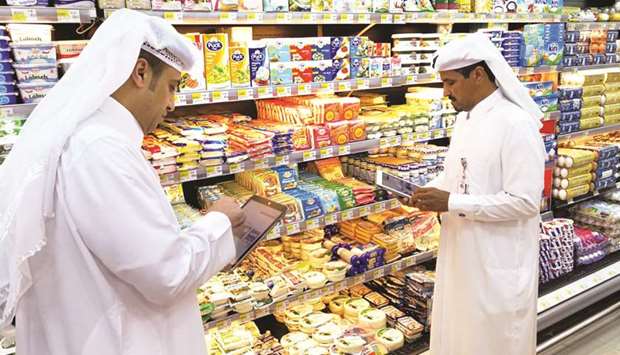 Municipal officials inspecting food items at an outlet.